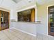 Sunroom with kitchen pass-through and access to the outdoors at 1323 Hammock Shade Dr, Lakeland, FL 33809