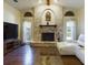 Living room boasts a fireplace, hardwood floors, and large windows at 1323 Hammock Shade Dr, Lakeland, FL 33809