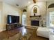 Living room with hardwood floors, fireplace, and sectional sofa at 1323 Hammock Shade Dr, Lakeland, FL 33809