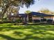 Single-story home with manicured lawn and mature trees at 1323 Hammock Shade Dr, Lakeland, FL 33809