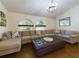 Spacious living room featuring a large sectional sofa and hardwood floors at 1323 Hammock Shade Dr, Lakeland, FL 33809