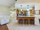 Open concept kitchen with breakfast bar and views into living room at 1323 Hammock Shade Dr, Lakeland, FL 33809