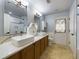 Updated bathroom with double vanity, large mirror, and a shower/tub combo at 1323 Hammock Shade Dr, Lakeland, FL 33809