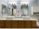 Double vanity bathroom with a large countertop and modern light fixtures at 1323 Hammock Shade Dr, Lakeland, FL 33809