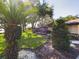 Landscaped front yard with palm tree and lush greenery at 1323 Hammock Shade Dr, Lakeland, FL 33809