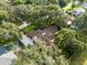 An aerial view showcasing a home with mature landscaping and a large backyard at 1323 Hammock Shade Dr, Lakeland, FL 33809