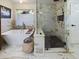 Spa-like bathroom with soaking tub, marble tile and walk-in shower at 1323 Hammock Shade Dr, Lakeland, FL 33809