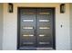 Modern black double front door with glass panels adds curb appeal at 659 Howard Ave, Lakeland, FL 33815