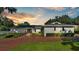 Brick front of a ranch house with a modern door and landscaping at 659 Howard Ave, Lakeland, FL 33815