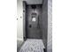 Walk-in shower with grey tile and pebble floor at 659 Howard Ave, Lakeland, FL 33815