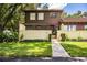 Two-story townhome with brown exterior and landscaped yard at 11 Loma Verde # 11, Lakeland, FL 33813