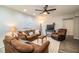 Living room features brown couches, a coffee table, and a large TV at 11 Loma Verde # 11, Lakeland, FL 33813