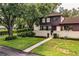 Two-story townhome with a gated entry and manicured lawn at 11 Loma Verde # 11, Lakeland, FL 33813