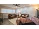Living room with brown couches, coffee table, and a large TV at 11 Loma Verde # 11, Lakeland, FL 33813