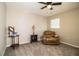 Relaxing bedroom with comfortable recliner and ceiling fan at 11 Loma Verde # 11, Lakeland, FL 33813