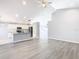 Open concept living room with kitchen view and vinyl plank flooring at 665 Lake Clark Pl, Lakeland, FL 33813