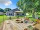 Backyard with deck, fire pit, and mature trees at 665 Lake Clark Pl, Lakeland, FL 33813