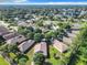 Aerial view showcasing a residential neighborhood with houses and green spaces at 665 Lake Clark Pl, Lakeland, FL 33813