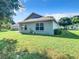 Spacious backyard with grassy area and mature trees at 665 Lake Clark Pl, Lakeland, FL 33813