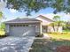 Single-story home with attached garage and landscaped yard at 665 Lake Clark Pl, Lakeland, FL 33813