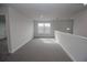 Bright loft area with gray carpeting and a window at 4538 Grandview Glen Dr, Auburndale, FL 33823