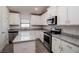 Modern kitchen with white cabinets, granite counters and island at 4544 Grand View Glen Dr, Auburndale, FL 33823