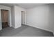 Simple bedroom with carpet, and two doors leading to other rooms at 4544 Grand View Glen Dr, Auburndale, FL 33823