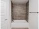Bathroom with a shower/tub combo and wood-look tile at 4544 Grand View Glen Dr, Auburndale, FL 33823