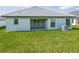 Home with covered patio and grassy backyard at 4544 Grand View Glen Dr, Auburndale, FL 33823