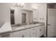 Bathroom with double vanity, granite countertop, and modern light fixtures at 4544 Grand View Glen Dr, Auburndale, FL 33823