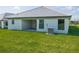 New home with large backyard, covered patio, and AC unit at 4544 Grand View Glen Dr, Auburndale, FL 33823