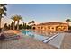 Community pool with lounge chairs and a clubhouse in the background at 4544 Grand View Glen Dr, Auburndale, FL 33823