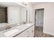 Double vanity bathroom with granite countertops and a view of a hallway at 4544 Grand View Glen Dr, Auburndale, FL 33823