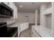 Modern kitchen featuring granite countertops, stainless steel appliances, and white cabinetry at 4544 Grand View Glen Dr, Auburndale, FL 33823
