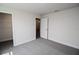 Bedroom with grey carpet, a closet and an open door to a hallway at 4544 Grand View Glen Dr, Auburndale, FL 33823
