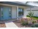 Covered front porch with paver walkway and landscaping at 4544 Grand View Glen Dr, Auburndale, FL 33823