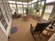 Bright sunroom with wicker furniture and screened windows at 323 Travelers Dr, Polk City, FL 33868