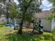 Backyard with playset and mature trees at 6445 Forestwood W Dr, Lakeland, FL 33811