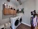 Laundry room with washer, dryer, and ample cabinet storage at 6445 Forestwood W Dr, Lakeland, FL 33811