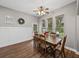 Bright dining room features wood table and chairs, wood flooring, and large windows at 6445 Forestwood W Dr, Lakeland, FL 33811