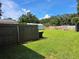 Large backyard with wooden fence, storage shed and fire pit at 1904 Sandford Rd, Lakeland, FL 33801