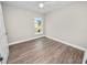 Bright bedroom with wood-look floors and a window at 522 S Perry Ave, Fort Meade, FL 33841