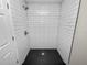 Modern shower with hexagon tile floor and white subway tile walls at 522 S Perry Ave, Fort Meade, FL 33841