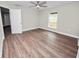 Spacious bedroom with wood-look flooring and ceiling fan at 522 S Perry Ave, Fort Meade, FL 33841