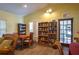 Community room with comfortable seating, bookcases, and a small table at 103 Coventry Ln, Haines City, FL 33844