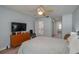 Spacious bedroom with a double bed, dresser, and access to a bathroom at 103 Coventry Ln, Haines City, FL 33844
