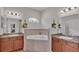 Elegant bathroom with double vanities, a corner soaking tub, and tile flooring at 1955 Danes Ct, Lakeland, FL 33810