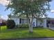 Single-story home with carport, landscaping, and large tree at 462 Cameo Dr # 462, Lakeland, FL 33803