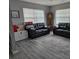 Living room featuring two black leather couches, a wooden storage chest, and a grandfather clock at 462 Cameo Dr # 462, Lakeland, FL 33803