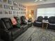 Living room with three black leather reclining chairs and a large wall art piece at 462 Cameo Dr # 462, Lakeland, FL 33803